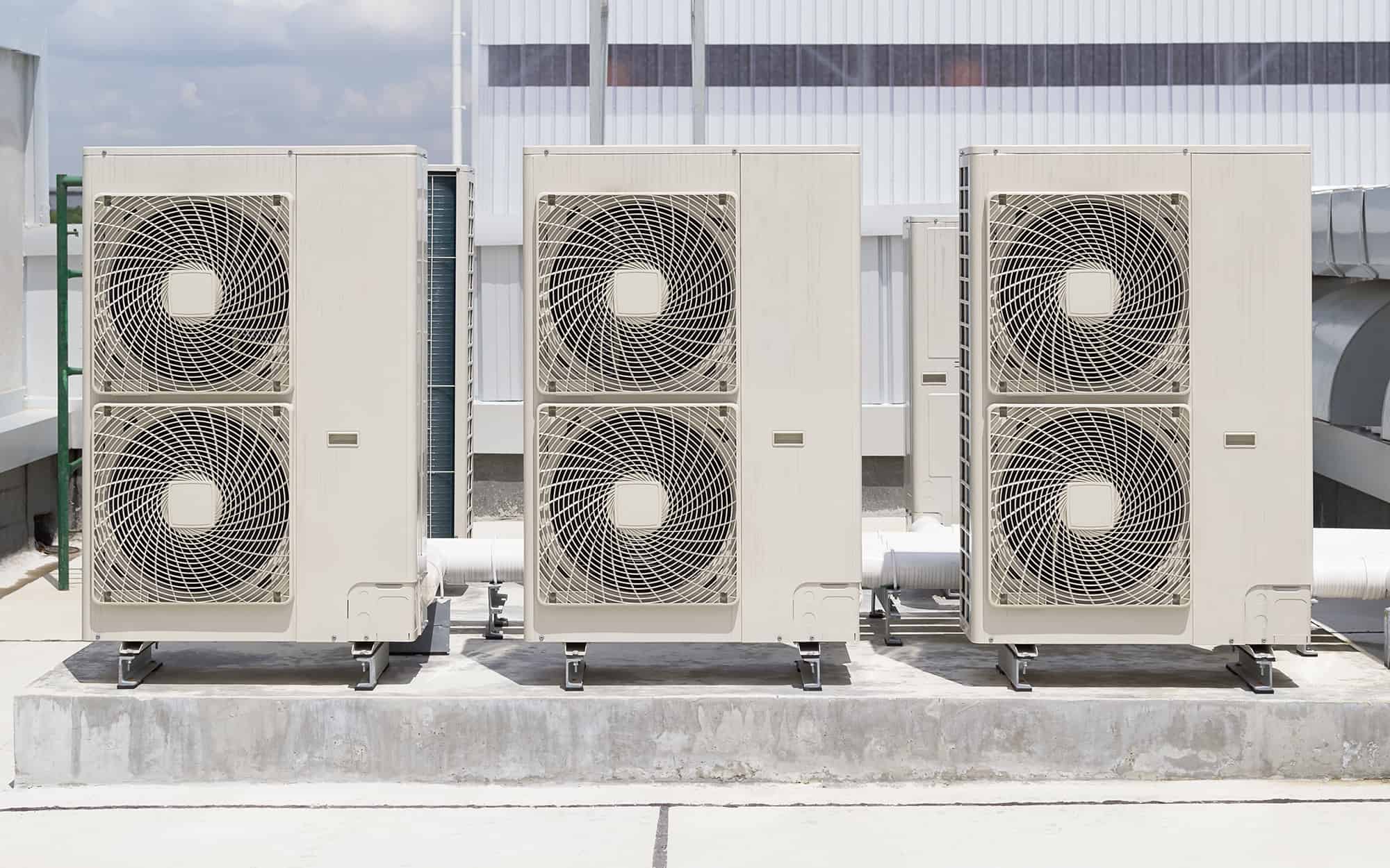 Condenser unit or compressor on roof of industrial plant building with sky background